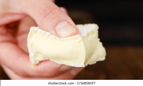 Fingers Squeeze A Piece Of Soft Cheese Camembert Or Brie. Creamy Soft Cheese Camembert Inside. White Mold Cheeses With Soft Textures.