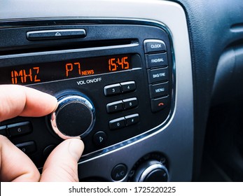 Fingers Turn The Volume Of The Car Radio