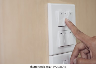fingers are turning off light switch in the house,Concept : Save Energy, Save World, Save money, Selective focus.