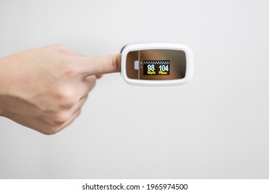 Fingertip Pulse Oximeter On The Finger Of Child Girl Measuring Heart Rate (pulse) Checking Oxygen Saturation (SpO2) Level In The Blood,diagnosis Of Coronavirus Or COVID-19 At Home,health Care Concept