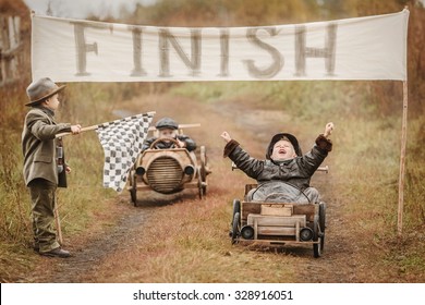 Finish of competition between the two little boys racers on homemade wooden car. Retouch for retro
