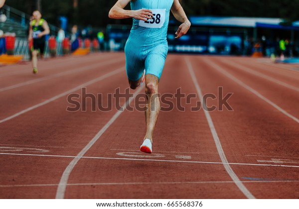 finish line leader male runner of  race sprint\
distance at stadium