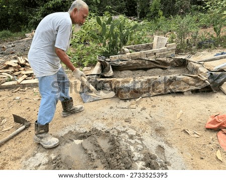 A finished cement base marks completion stage of a DIY backyard duck pond construction project.