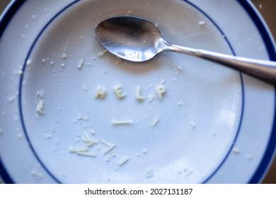 Finished plate food pasta noodles with spoon spelling the word Help - Shutterstock ID 2027131187