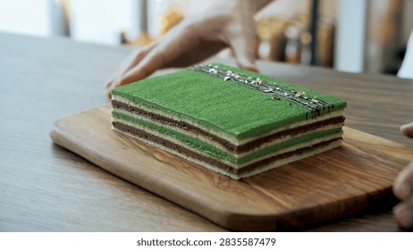 Finished rectangular matcha layer cake presented in a detailed culinary, dessert, or fresh food setting.
