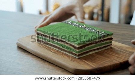 Finished rectangular matcha layer cake presented in a detailed culinary, dessert, or fresh food setting.