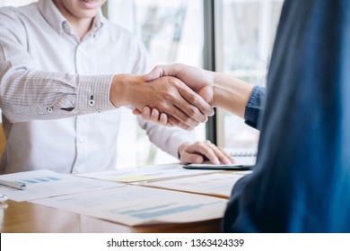 Finishing up a conversation after collaboration, handshake of two business people after contract agreement to become a partner, collaborative teamwork.