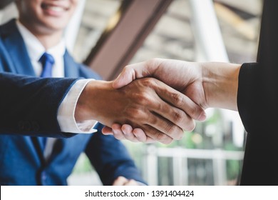 Finishing up a meeting, handshake of two happy business people after contract agreement to become a partner, collaborative teamwork.