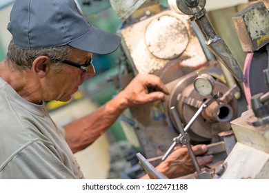 Finishing Metal Working On Lathe Grinder Machine: Factory Worker Measure Detail Radial Run-out With Dial Indicator Tool During Rotation Around A Fixed Axis