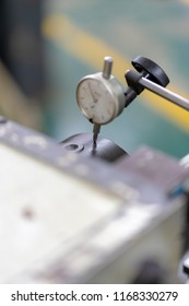 Finishing Metal Working On Lathe Grinder Machine: Factory Worker Measure Detail Radial Run-out With Dial Indicator Tool During Rotation Around A Fixed Axis
