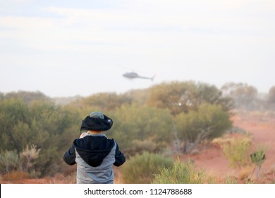 Finke, Northern Territory, Australia - June 9, 2018: Tatts Finke Desert Race Observer Trackside With Race Helicopter Overhead.