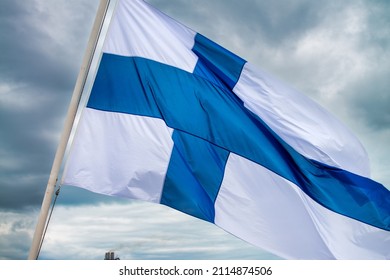 Finland national flag waving in the wind on a cloudy sky