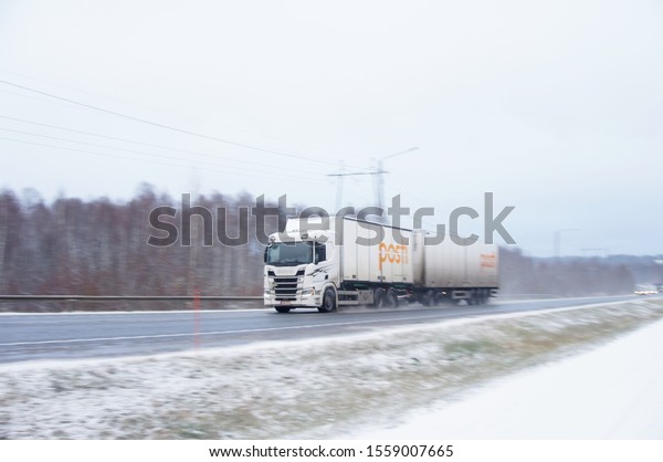 Hämeenlinna, Finland - November 8 2019 :\
Finnish Post truck speeding at slippery and icy\
highway