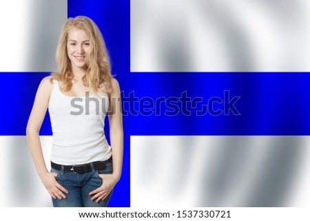 Finland. Young cute happy woman with Finnish flag background