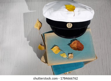 Finnish Autumn High School Graduation Concept Picture With Graduation Hat Old Books And Yellow Leaves