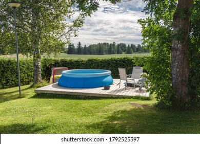 Finnish country house yard. Playground. Children's playhouse. Inflatable pool in the yard. - Shutterstock ID 1792525597