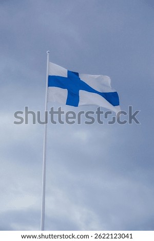 Finnish flag with cloudy sky