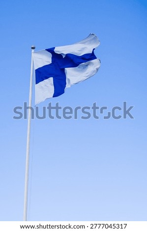 Finnish Flag Fluttering Against Gradient Blue Sky