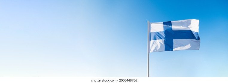 Finnish flag waving in wind and sunlight. Flag of Finland on blue sky background. Empty copy space for text. Finland independence day. - Powered by Shutterstock
