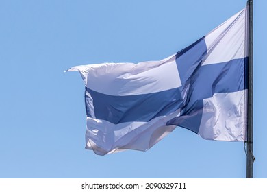 Finnish national flag waving on blue sky background. Republic of Finland, FIN - Shutterstock ID 2090329711