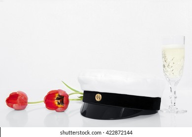 Finnish Student Cap, Ylioppilaslakki With White Background, Glass Of Champagne And Two Red Tulips