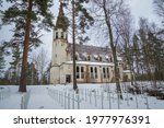 Finnish war cemetery and the abandoned church of Lumivaara on a gloomy February day. Karelia, Russia