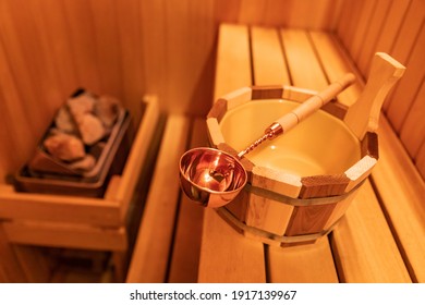 Finnish wooden Sauna small private room with traditional accessories.