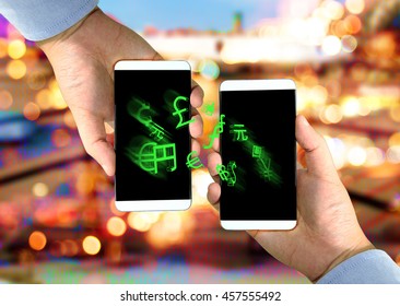Fintech concept image. Two smart phones exchange world currencies sign on screen against coded abstract bokeh background. Representing Transfer money by coded money or digital money.