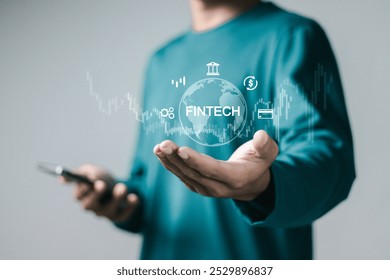 Fintech (financial technology), digital banking concept. Businessman using smartphone with digital finance icons. Internet payment, online shopping, financial technology. - Powered by Shutterstock