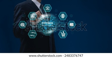 FinTech, Financial technology and Digital banking concept. Businessman interacting with a holographic globe representing fintech, surrounded by icons related to online finance. Mobile banking.