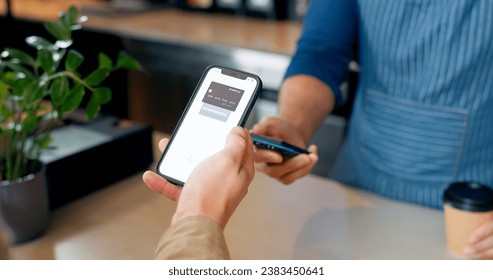 Fintech, phone or hands of customer in cafe with cashier for shopping, sale or payment in checkout. Machine, bills or closeup of person paying for service, coffee or tea drink in restaurant or diner - Powered by Shutterstock