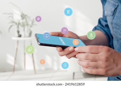 Fintech service balloons flying around phone in woman hands concept. Dynamic visuals illustrate seamless accessibility to modern financial services, enhancing the digital banking experience