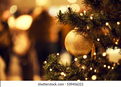 Fir branch with balls and festive lights on the Christmas background with sparkles. - Powered by Shutterstock