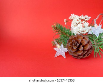 Fir Tree Branches With Christmas Decoration On Red Background. Free Copy Space. High Quality Photo