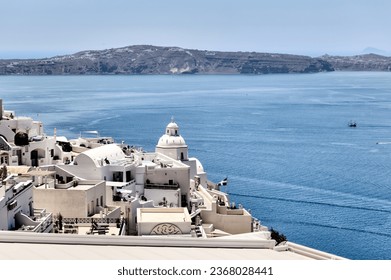 Fira, Greece - July 20, 2023: The architectural dome of the Saint Minas Holy Orthodox Church in Fira, Santorini, Greece
