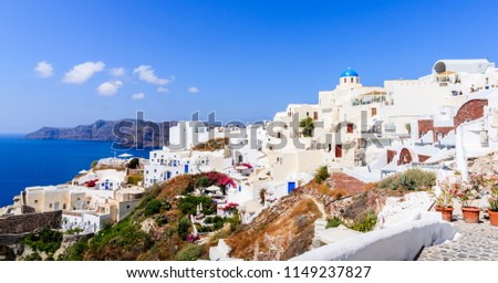 Fira town on Santorini Island, Greece. Oia village in the summer. 
Whitewashed houses and blue dome church by the Aegean Sea.
Santorini is the lovers island.