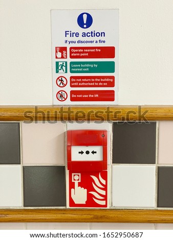 Fire action plan sign and manual fire alarm point in public work place