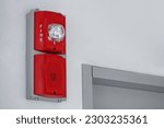 Fire alarm with built in emergency strobe light and sounder installed on the wall in public building.