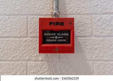 Fire Alarm Switch On White Brick Wall, Break Glass Press Here, Safty System Concept, Copyspace And Background.