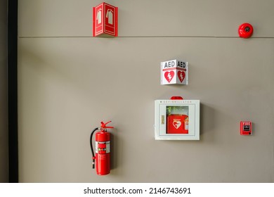 Fire Alarm System On A Brick An Emergency During Fire.Automated External Defibrillator AED Emergency Life Saving Equipment Mounted On Wall Of Rowing Club.