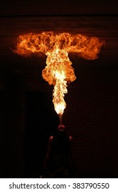 Fire artist performing extreme fire breathing 