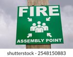 Fire assembly point sign on a wooden post