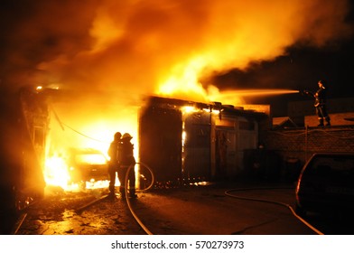 Fire in auto repair shop - Shutterstock ID 570273973