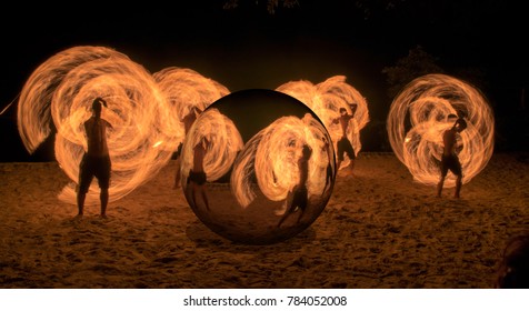 Fire baton show by man, crystal sphere effect