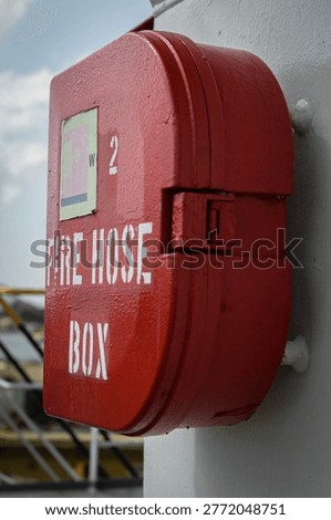 Fire box containing fire hose, spanner and a nozzle