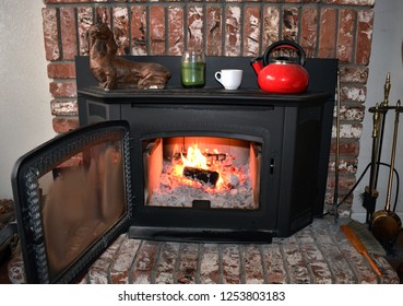 Fire In Brick Fireplace And Mantle Inside A Cozy Family Room