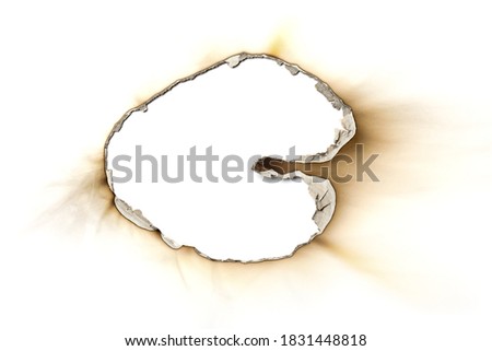 Fire burned hole white paper background texture isolated on white background. Paper burn mark stain
