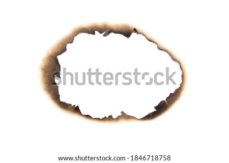 Fire burned hole white paper background texture isolated on white background. Paper burn mark stain