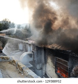 Fire Burning And Black Smoke Over The House.