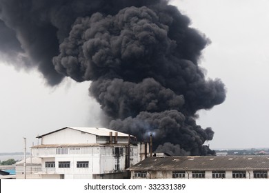 Fire Burning And Black Smoke Over The Factory.